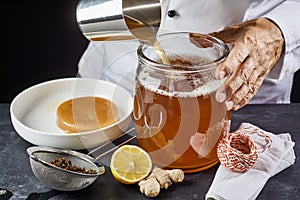 Man pouring a brew of sweetened black tea photo