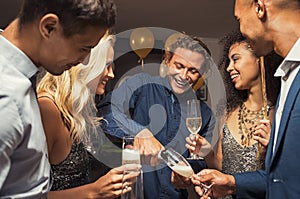 Man pouring champagne in flutes