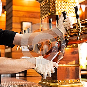 Man pouring, filling beer glass, mug