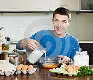 Man pouring milk in bowl