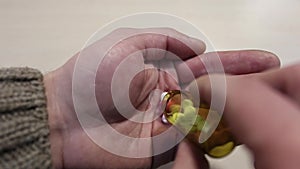 Man pouring pills from the jar on his palm