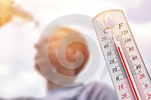 Man pouring water on his head in extreme heat, Thermometer in summer day shows or indicate high temperature