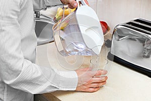 Man pours filtered water