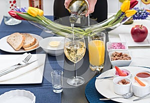 Man pours white wine into a glass