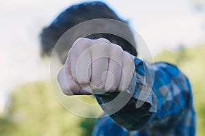 Man power fist in anger closeup. Strong gesture