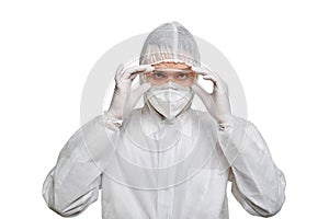 A man in PPE and safety glasses looks at the camera.