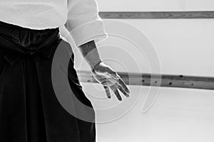 Man practicing aikido in a dojo background.