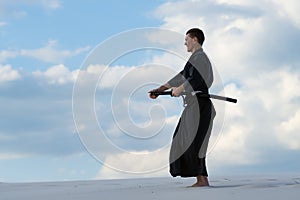 Man practicing Japanese martial art in desret