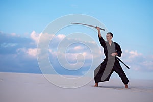 Man is practicing with a Japanese sword - a katana