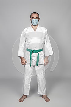 Man practicing martial arts wearing a surgical mask