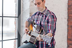 Man practicing in playing guitar focus on hand and chord