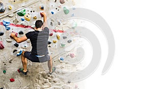 Man practicing rock climbing on artificial wall indoors. Active lifestyle and bouldering concept with copy space