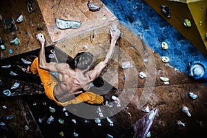 Man practicing rock-climbing on a rock wall