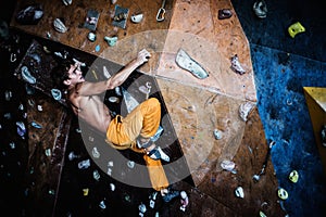 Man practicing rock-climbing on a rock wall