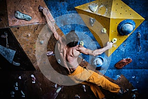 Man practicing rock-climbing on a rock wall