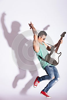 Man practicing rock on electric guitar