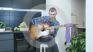 Man practicing to play chords on acoustic guitar at home. Professional musician play guitar and singing song. Guitarist performing