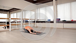 Man practicing yoga in the gym.Man doing yoga asanas in the light of the Studio. Bright Studio with large Windows and