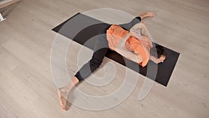 Man practicing yoga in the hall.Bright Studio with large Windows and mirrors. Sportswear