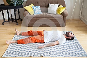 Man practicing yoga and meditation at home. A series of yoga poses. Lifestyle concept