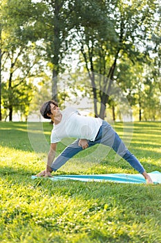 Man practicing  yoga in the park