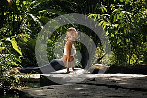 Man practicing yoga in tropic environment