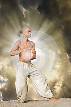 Man Practises Tai Chi holding a Ball of Energy