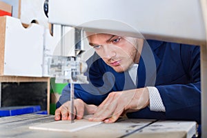 Man practising his skills with ribbon saw machine