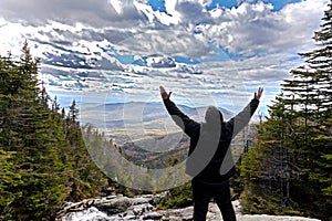 Man in praise looking out from elevation on Mount Washinton via