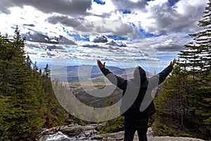 Man in praise looking out from elevation on Mount Washinton via