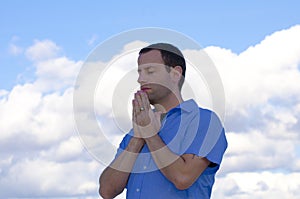 Man praying in the clouds.