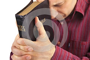 Man Praying Holding the Bible