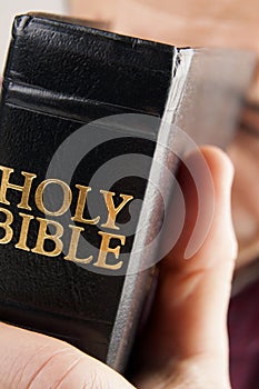 Man Praying Holding the Bible