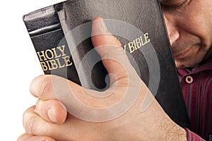 Man Praying Holding the Bible
