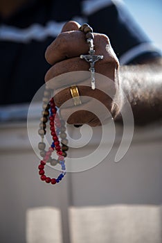 A man praying the holy Rosary - Rosary Beads Wood Rosaries Blue Red