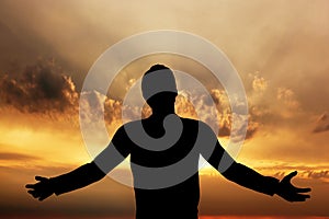 Man praying, meditating in harmony and peace at sunset