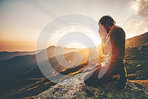 Man praying at sunset mountains