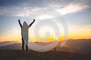 Man praying at sunset mountains raised hands Travel Lifestyle spiritual relaxation emotional concept, Freedom and travel adventure