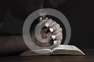 Man praying to God on a Bible