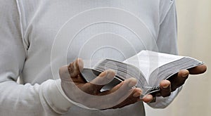 man praying to god with bible with background with people stock image stock photo