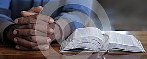 man praying to god with bible with background with people stock image stock photo