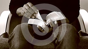 man praying to god with bible in hands caribbean man praying with background with people stock video stock footage