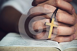 Man Praying to God with a Bible in the Morning Devotion photo