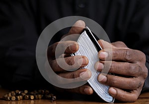 man praying to God with bible and worshipping with hands together Caribbean man praying with people stock video stock footage