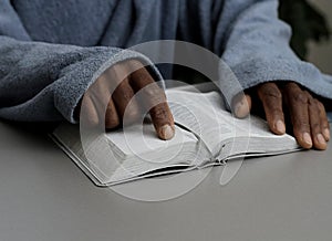 man praying to God with bible and worshipping with hands together Caribbean man praying with people stock video stock footage