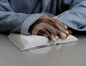 man praying to God with bible and worshipping with hands together Caribbean man praying with people stock video stock footage