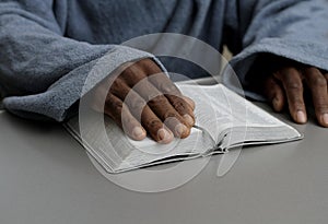 man praying to God with bible and worshipping with hands together Caribbean man praying with people stock video stock footage