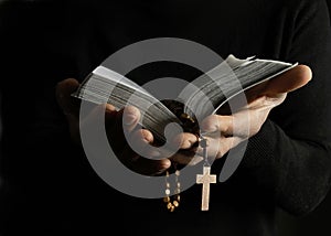 Man praying to god with hands together with black background stock photo