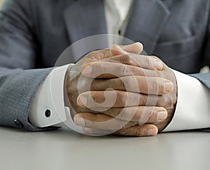 man praying to God worshipping with hands together Caribbean man praying with people stock image stock photo