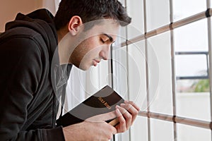Man Praying by Window